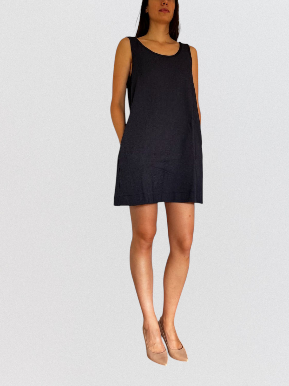 Invogue Again black denim pinafore dress worn by a model with beige heels, featuring a sleeveless, minimalist design.