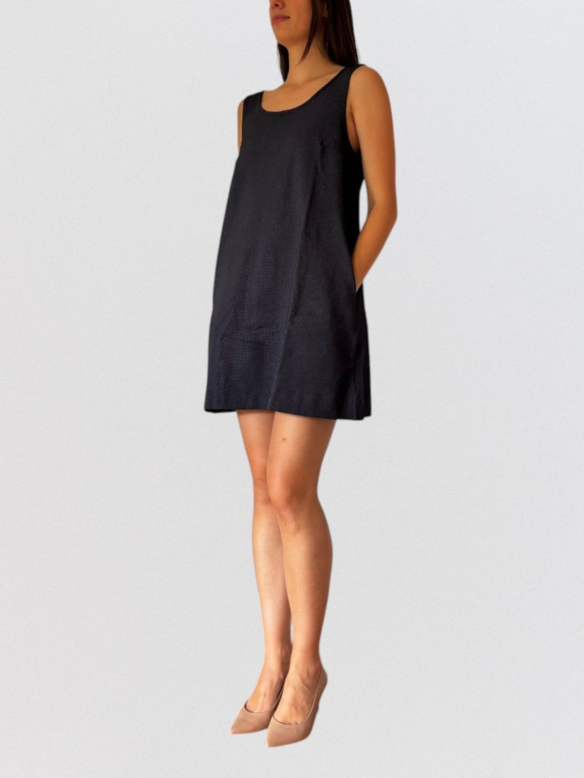 Invogue Again denim pinafore dress in dark blue with a sleeveless design, front pleats, and side pockets.