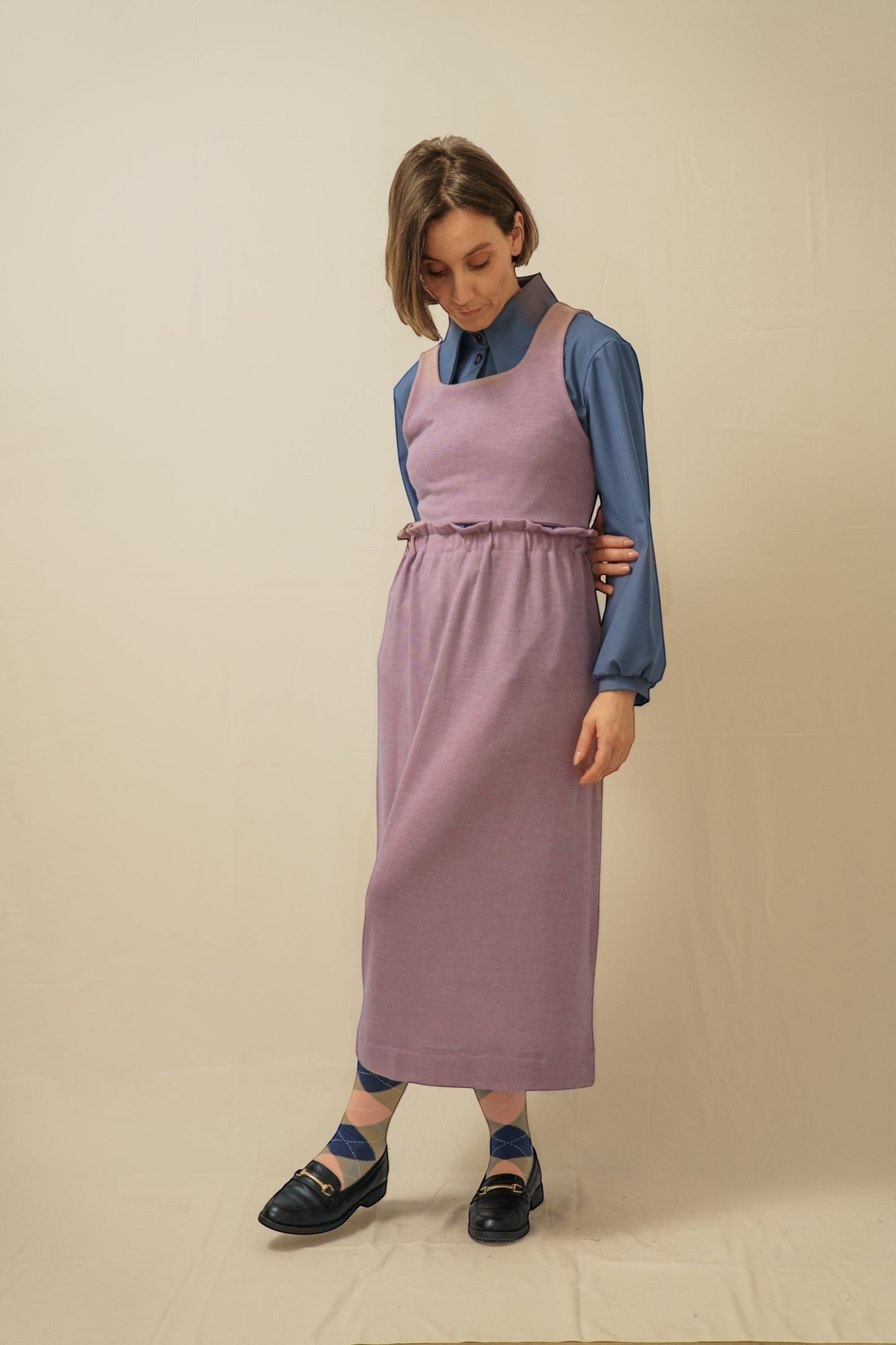 Invogue Again Malva mauve sleeveless midi dress with a ruffled waist, layered over a blue collared shirt.