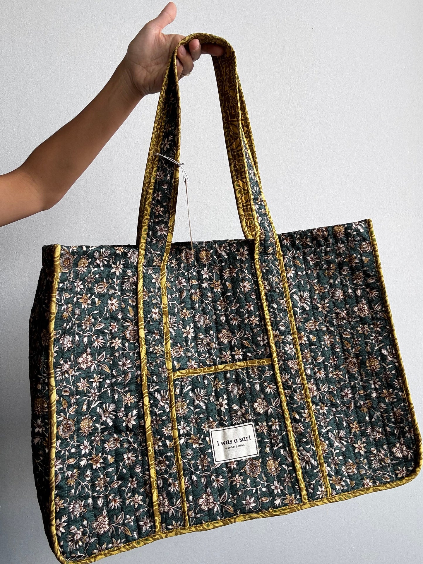 Invogue Again quilted work tote bag in dark green floral sari fabric with mustard yellow trim and shoulder straps.