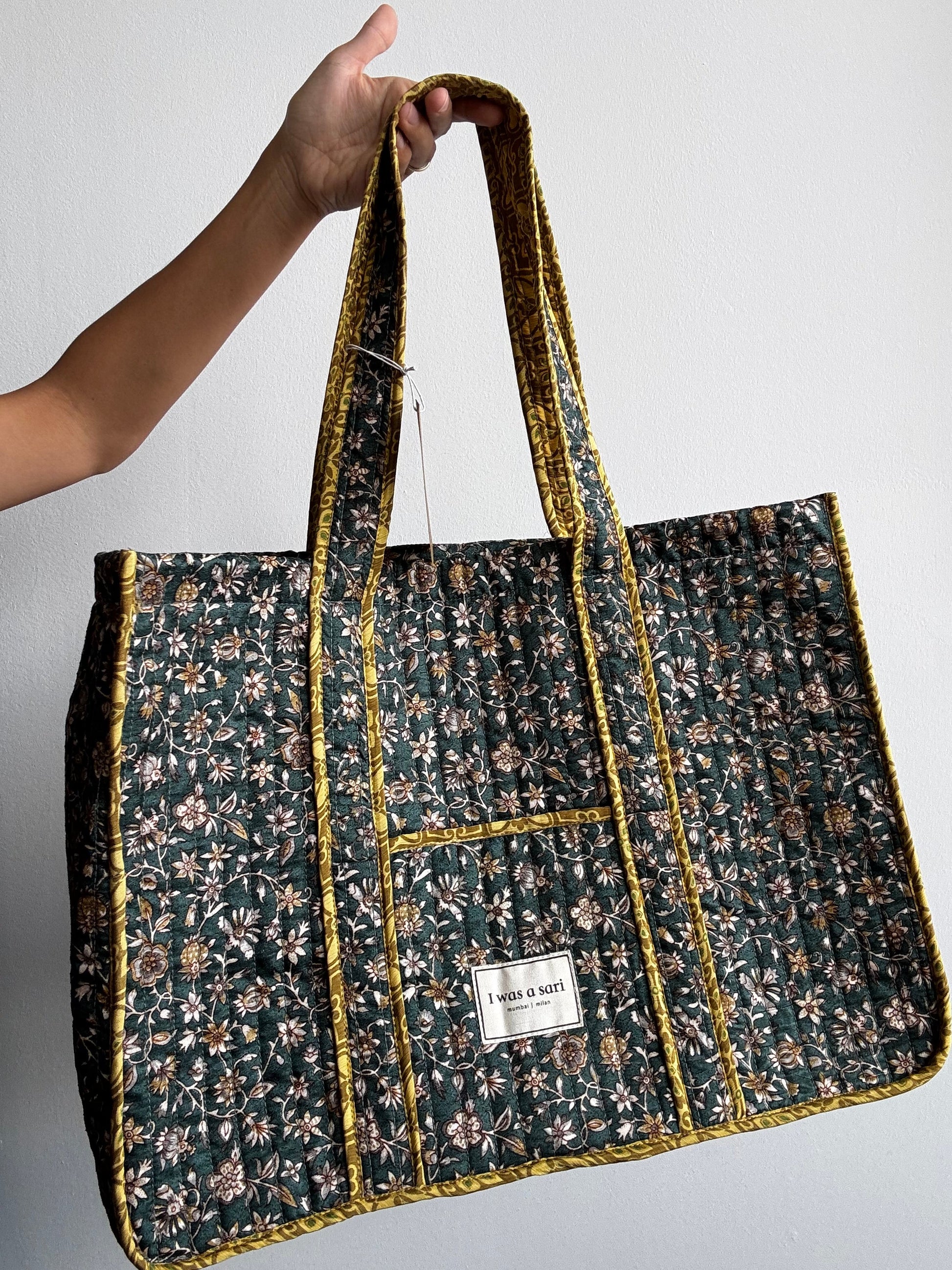 Invogue Again quilted work tote bag in dark green floral sari fabric with mustard yellow trim and shoulder straps.