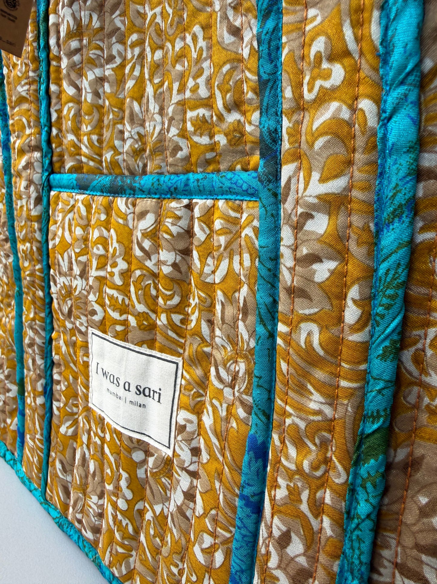 Invogue Again quilted work tote bag featuring mustard yellow and teal chevron sari fabric with a white brand label.